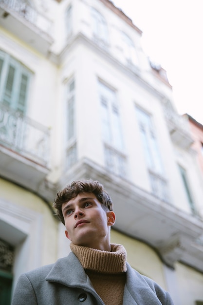 Free Photo low angle view young guy with turtle neck