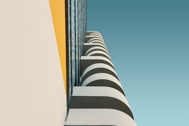 Low angle of a white concrete building under the clear blue sky