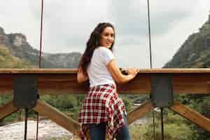 Free photo low angle woman on bridge in nature