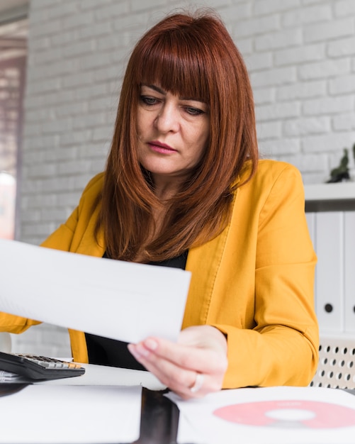 Free Photo low angle woman consulting documents