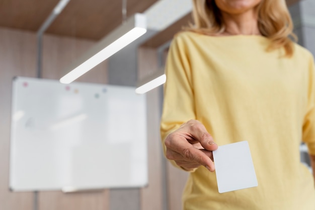 Low angle woman holding business card