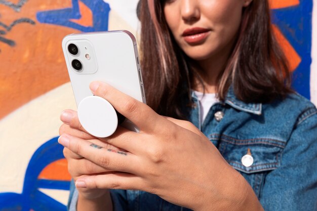 Low angle woman holding smartphone