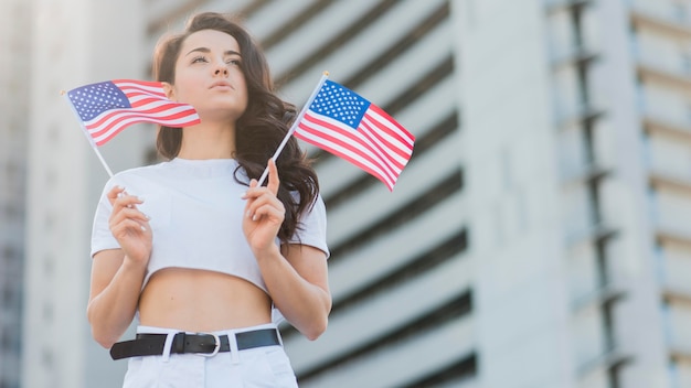 Low angle woman holding usa flags