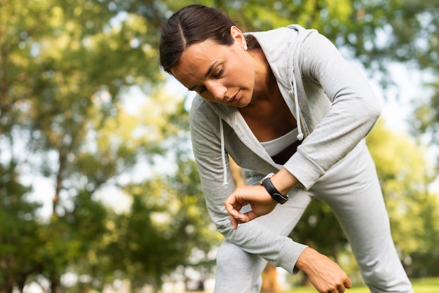 Low angle woman looking at her watch