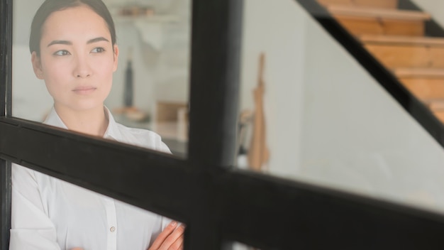 Low angle woman looking through window