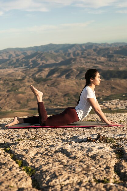 Low angle woman on mat yoga training