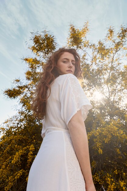 Low angle woman posing outdoors