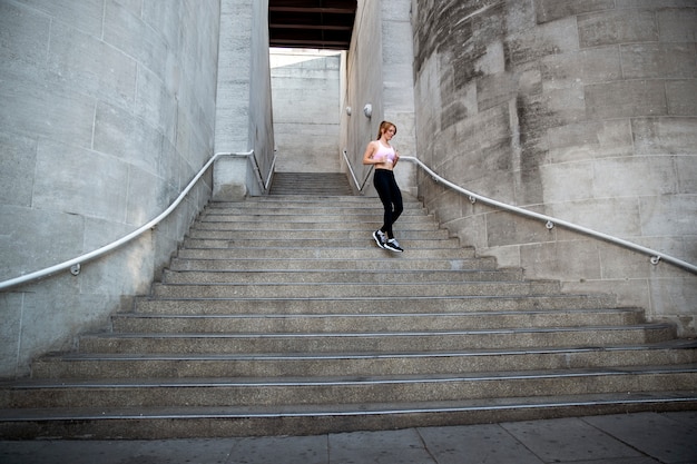 Low angle woman running down stairs