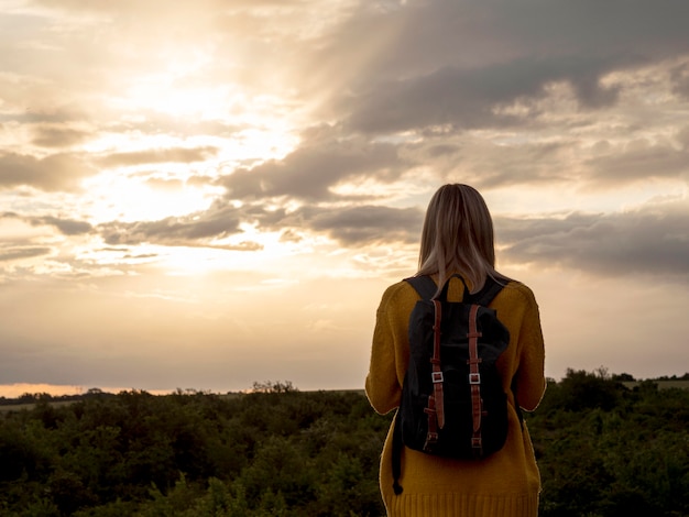 Low angle woman at sunset on mountain