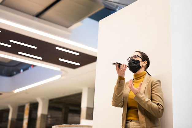 Low angle woman wearing mask