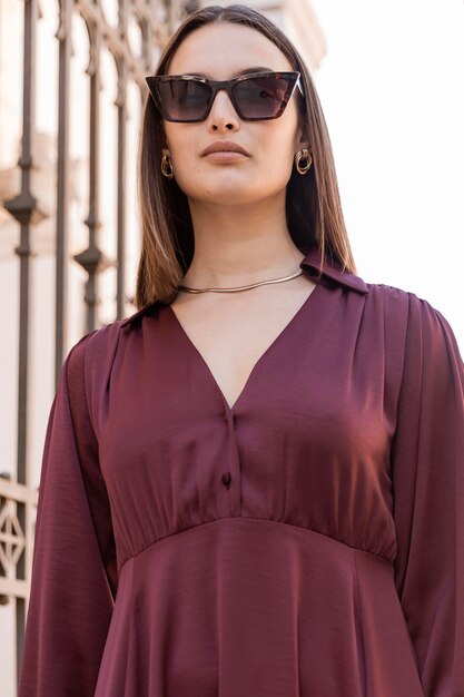 Free photo low angle woman wearing sunglasses