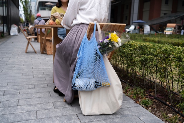 Free Photo low angle woman with fabric bag