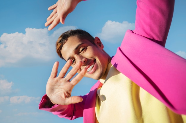 Free Photo low angle of young man in an outdoor field