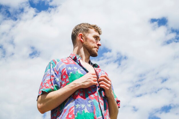 Low medium shot portrait of stylish man looking away