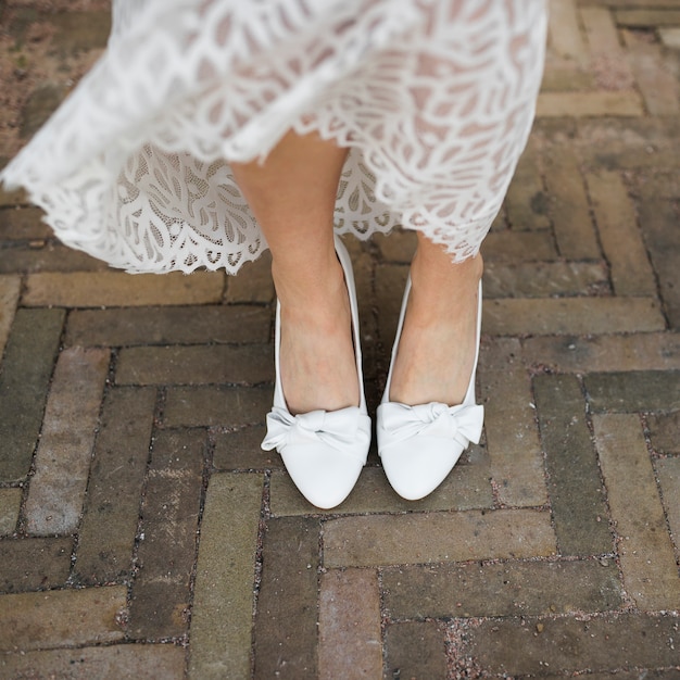 Free photo low section of bride's leg wearing white heels