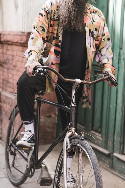 Free photo low section of a man riding bicycle outdoors