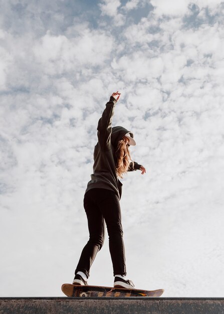 Low view skater girl and sky