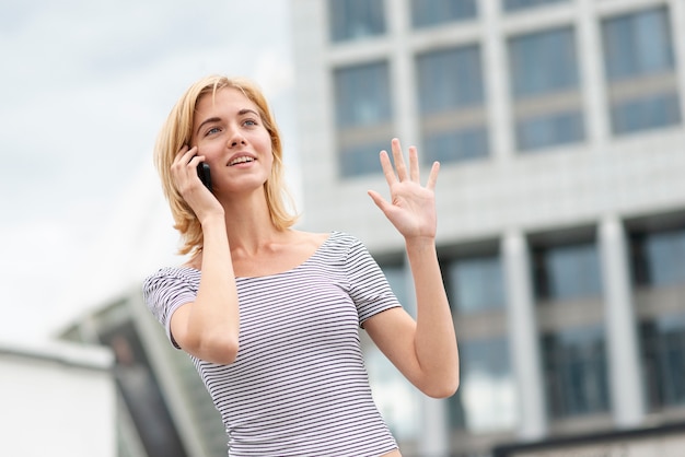 Free photo low view woman talking on the phone