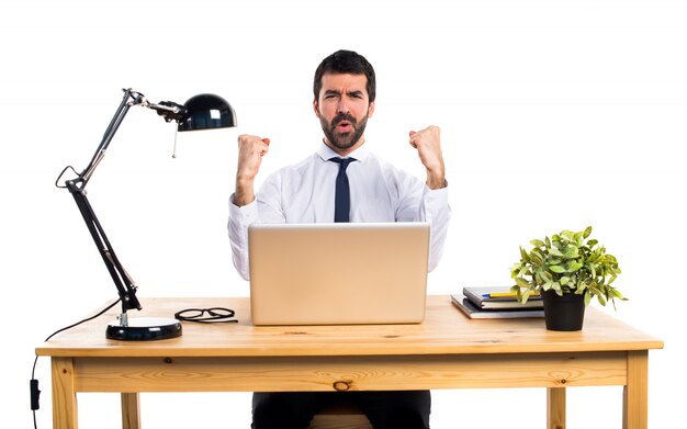 Free photo lucky businessman in his office