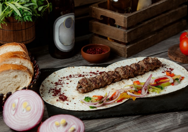 Free photo lule kebab with onion salad in lavash