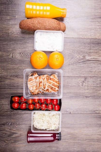 Free photo lunch packed in different boxes. fresh and healthy lifestyle. wooden background