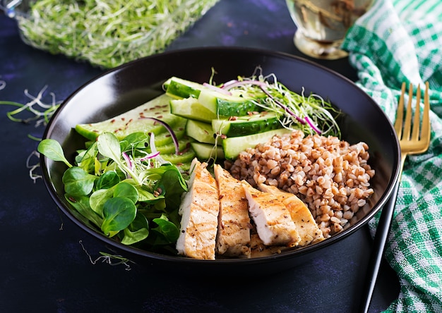 Lunch salad. Buddha bowl with buckwheat porridge, grilled chicken fillet, corn salad, microgreens and daikon. Healthy food.