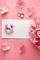 Free photo luxury wedding concept pink flowers and wedding rings