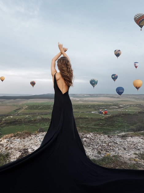 Free Photo luxury woman in dress with balloons backside