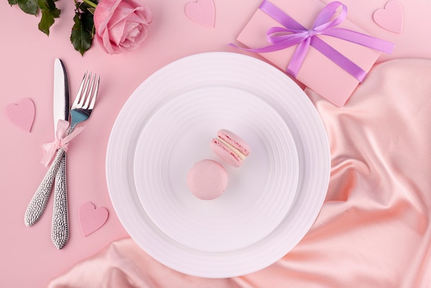 Macarons on plate with cutlery and gift