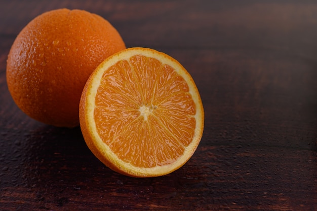 Macro image of ripe orange, on wood table