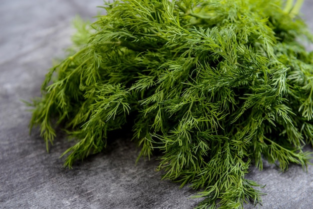 Macro picture of green dill on grey table