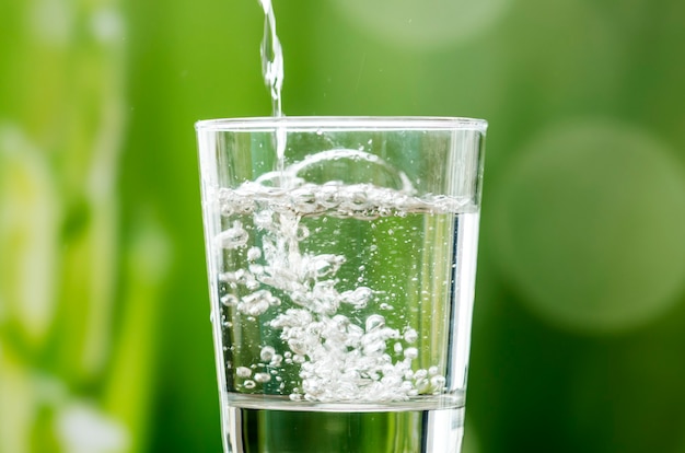 Macro shot of pouring water into a glass