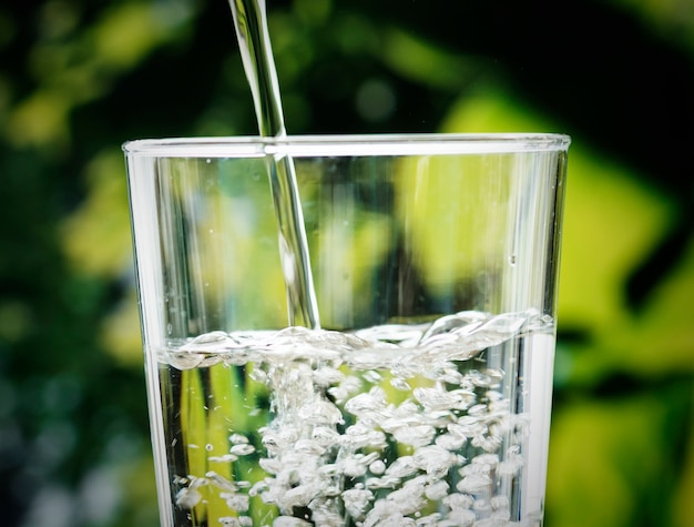 Macro shot of pouring water into a glass