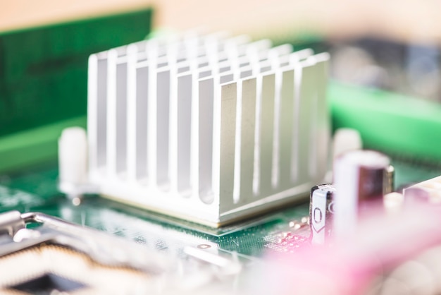 Free photo macro shot of white heatsink on motherboard circuit