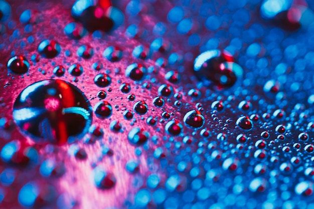 Macro of water drops on dvd surface with bokeh light