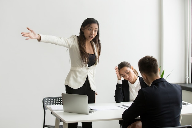 Mad HR representative pointing at door asking candidate to leave