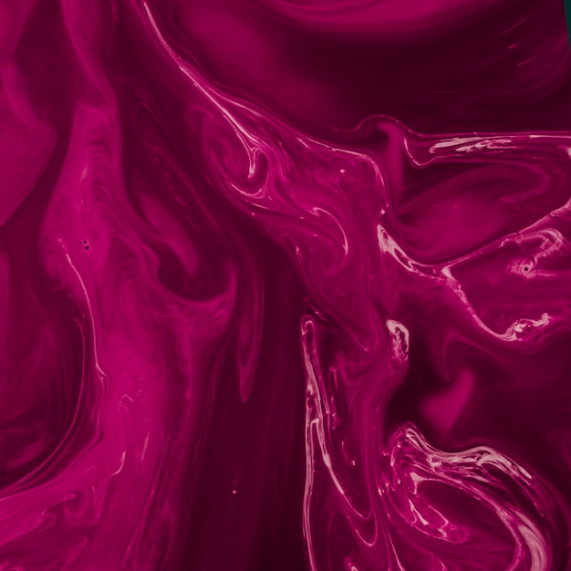 Free photo magenta marble liquid twist texture background