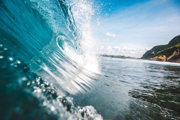 Magnificent view of a wave with rocksnin the background captured in Lombok, Indonesia