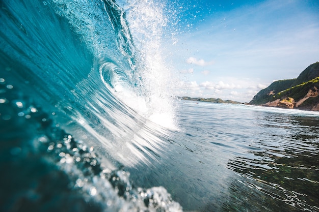 Magnificent view of a wave with rocksnin the background captured in Lombok, Indonesia