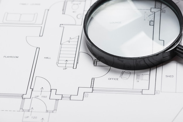 Free photo magnifying glass on blueprint