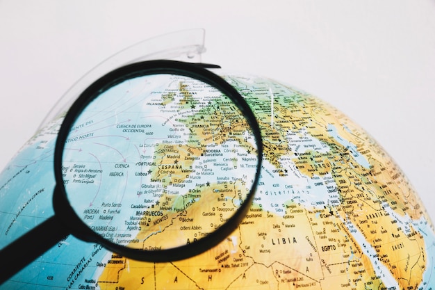 Magnifying glass near globe