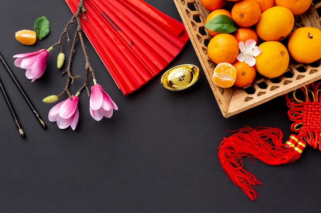 Free photo magnolia and tangerine basket chinese new year