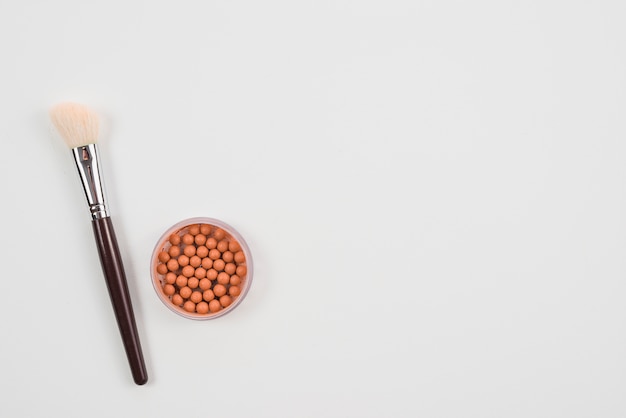 Free photo makeup brush and blush on white background