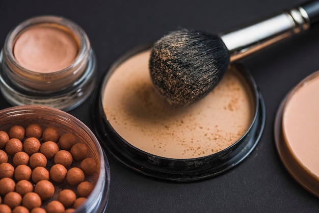 Makeup brush on compact powder with bronzing pearls