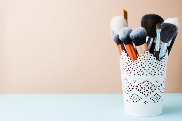 Free photo makeup brushes in lacy cup