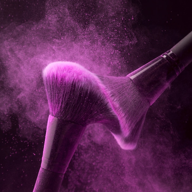 Makeup brushes with fuchsia powder haze