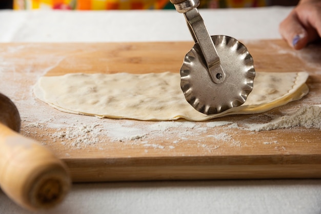 Making gutab on wooden board. Azerbaijan national cuisine. 