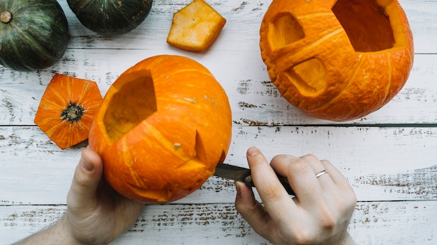 Free Photo making halloween carved pumpkin