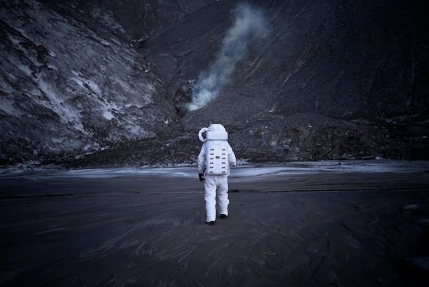 Male astronaut exploring at night during a space mission on an unknown planet