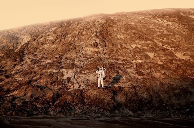 Free Photo male astronaut exploring during a space mission on another planet